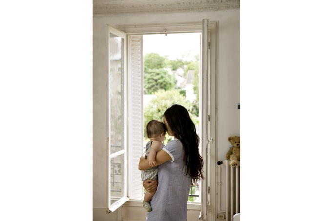 woman and child in front of open door in white interior - photography from danish photographer morten holtum http://www.holtum.dk/ 