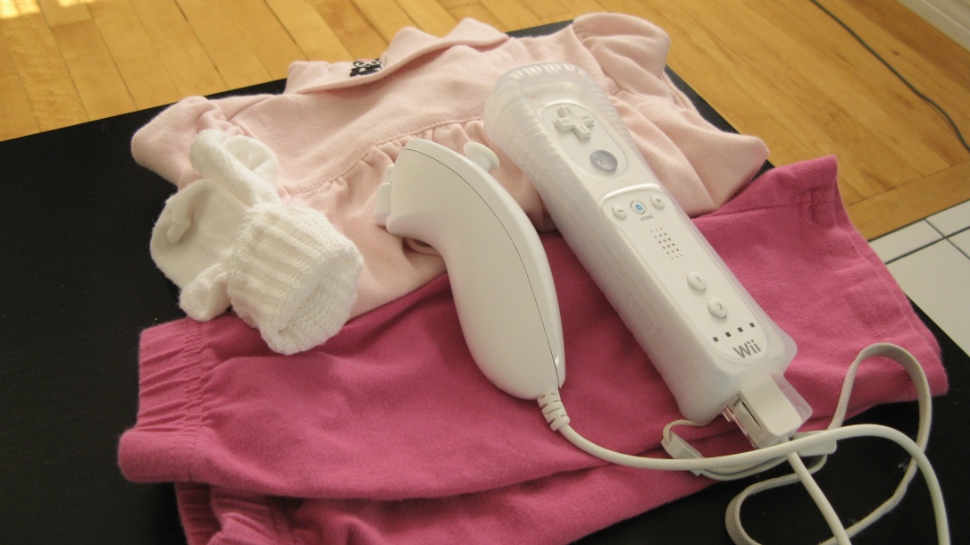pink baby girls clothes and wii controller