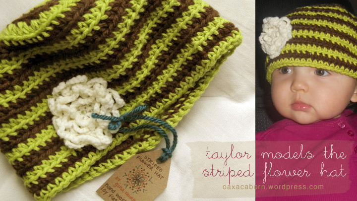 baby taylor models a handmade striped green and brown crocheted hat with an off-white flower