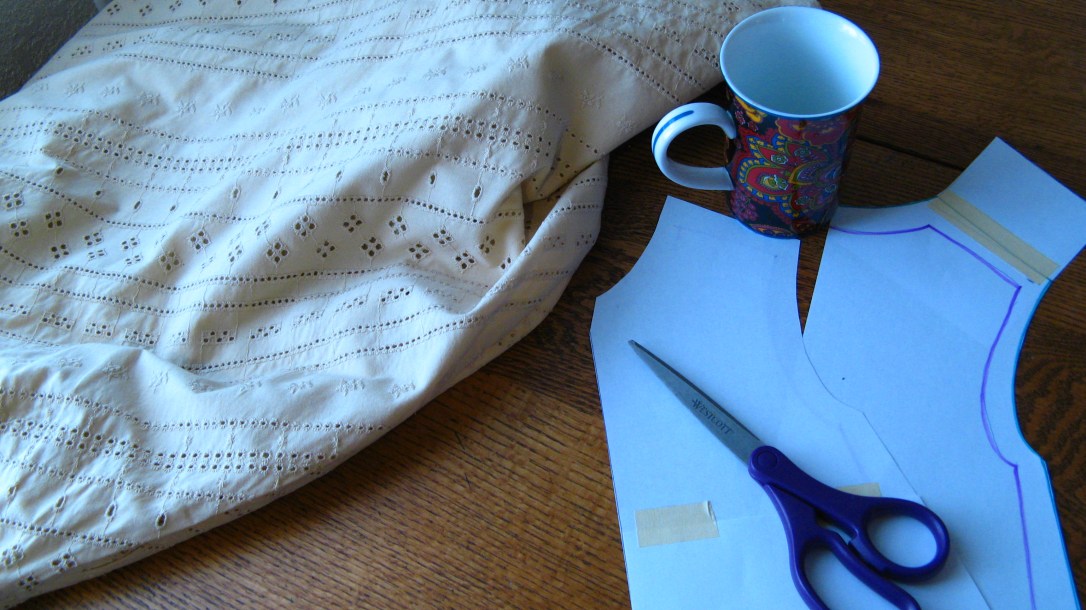 cutting a pattern for a little girl dress out of an old skirt