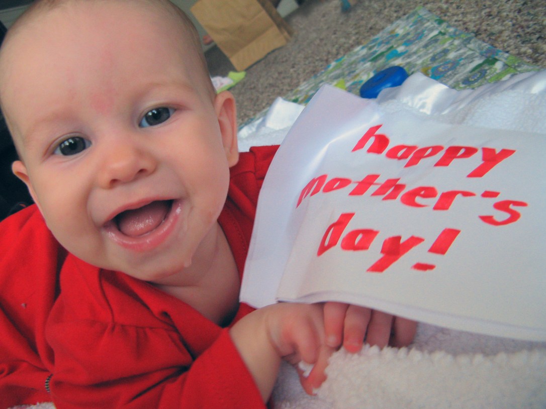 baby Aveline Alenka holding sign reading Happy Mother's Day