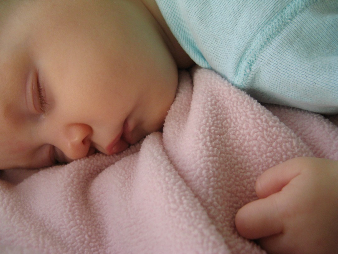 baby fast asleep on pink fleece blanket baby fast asleep on pink fleece blanket