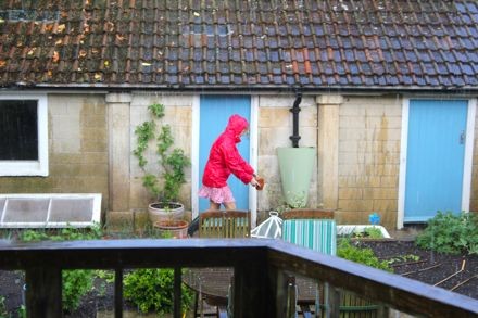 oaxacaborn outdoor pinterest board - cottage with blue doors, gardener in pink raincoat - via mytinyplot.co.uk