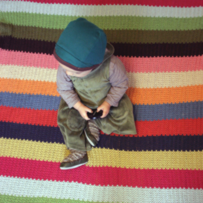 Artsy Ants - Sylvia - Photograph of  Child on Striped Blanket