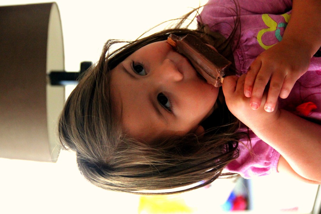 Amelia of More Fun with an Apron eating a homemade fudgepop with popsicle recipe