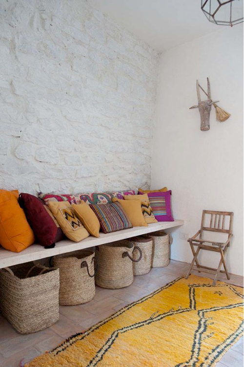 Italian Cottage via Cote Maison and Style Files - Yellow Rug, Stone Walls, Pillows, and Natural Baskets