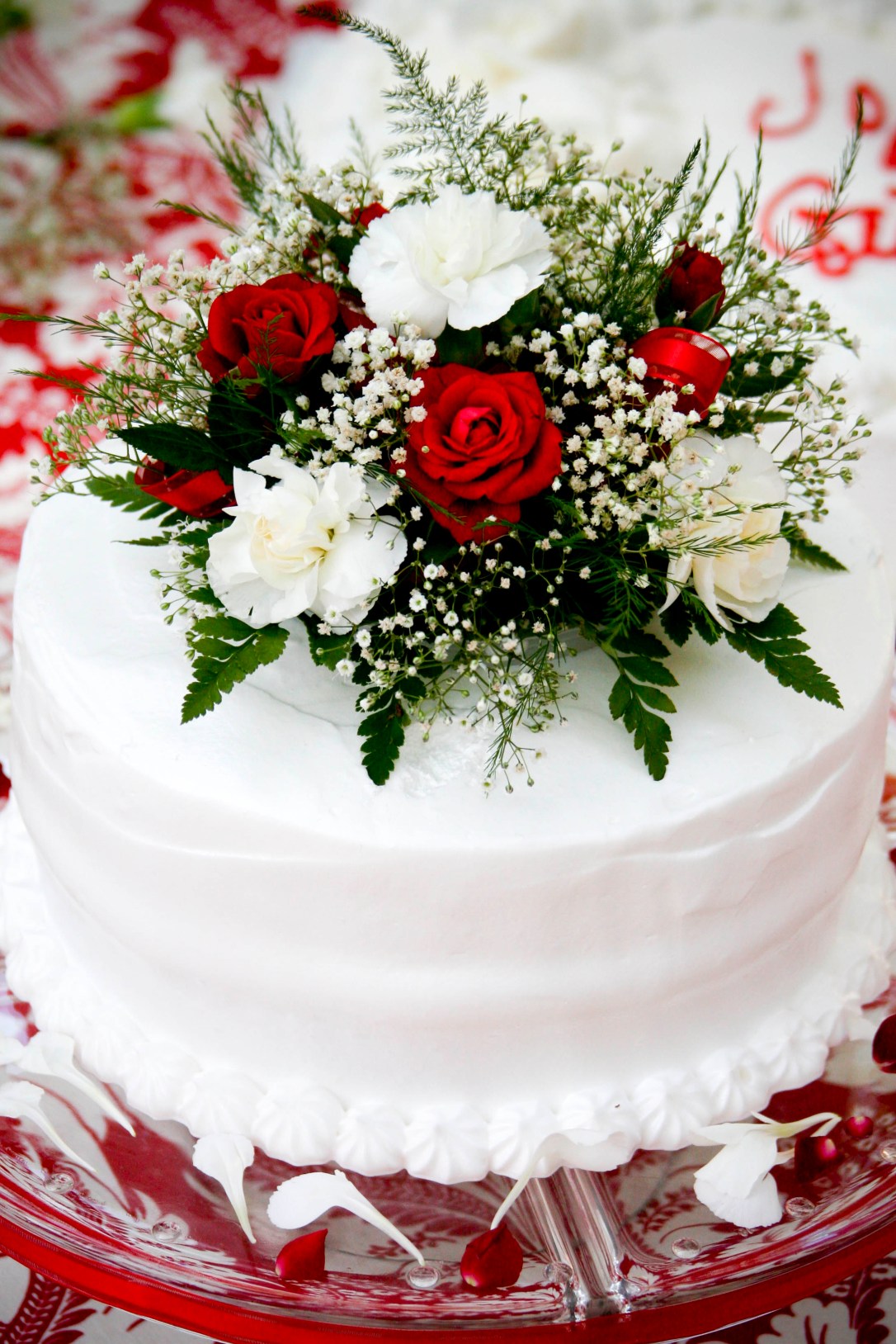 Wedding cake on red damask tablecloth