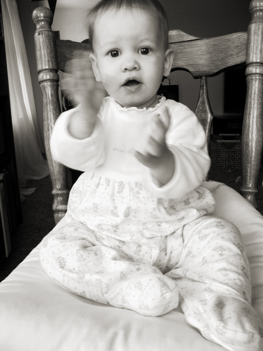 Aveline in pajamas in chair, clapping