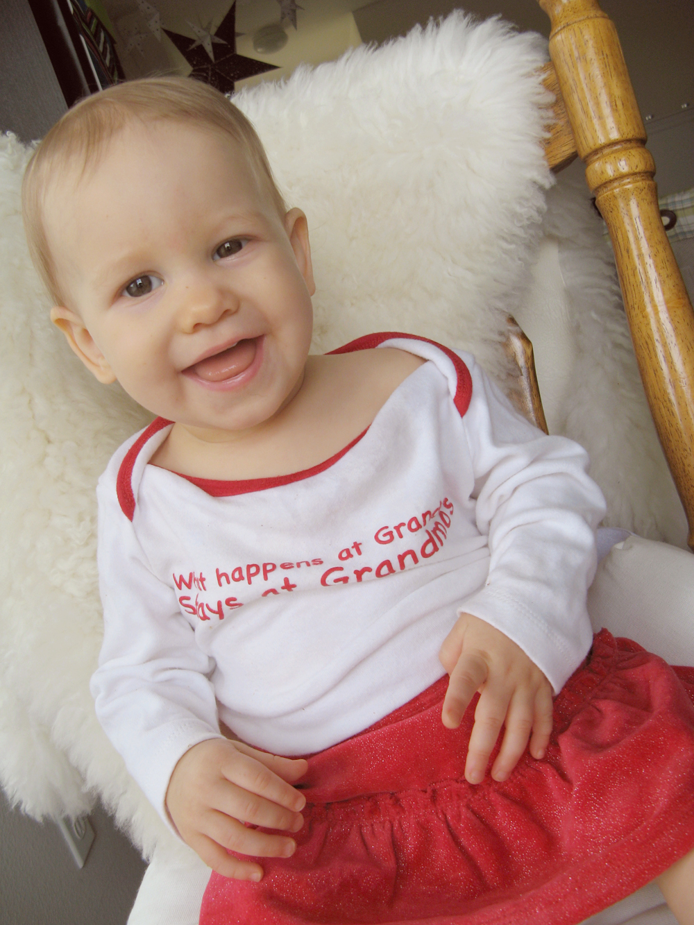 Aveline in What Happens at Grandma's Stays at Grandma's shirt, on chair