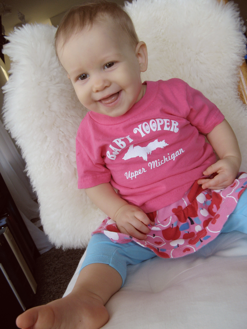 Aveline in Baby Yooper tshirt, leggings and skirt, on chair