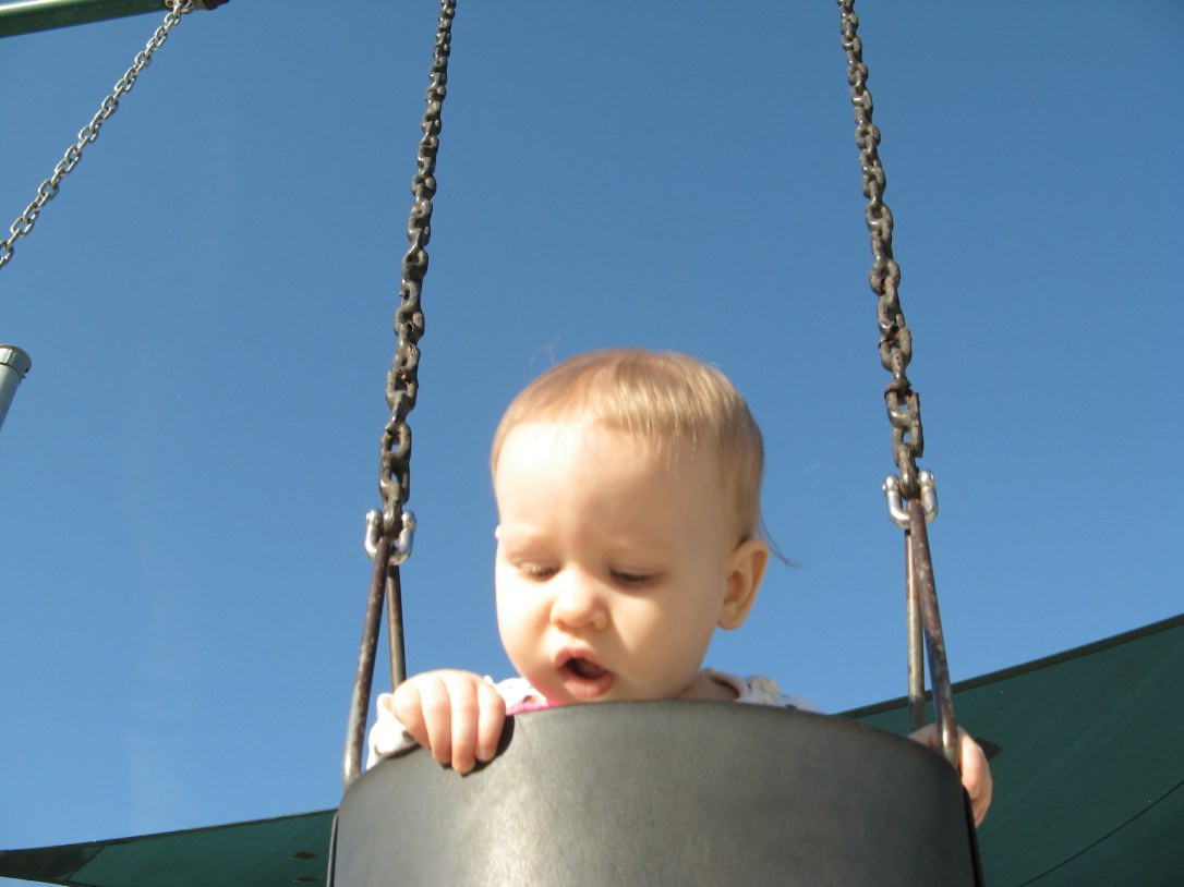 Aveline peeking over the edge of the swings Aveline peeking over the edge of the swings