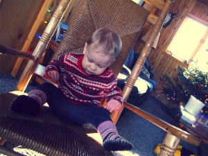 Aveline in huge wicker rocking chair at cabin in Upper Peninsula of Michigan