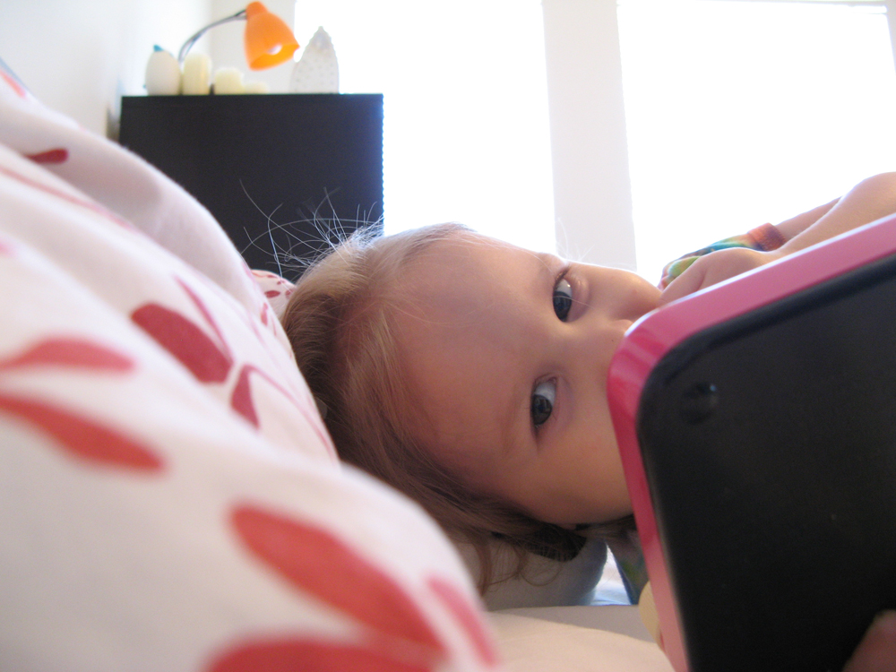 February 2013 - Aveline eating Ritz and playing Etch-a-Sketch in our bed