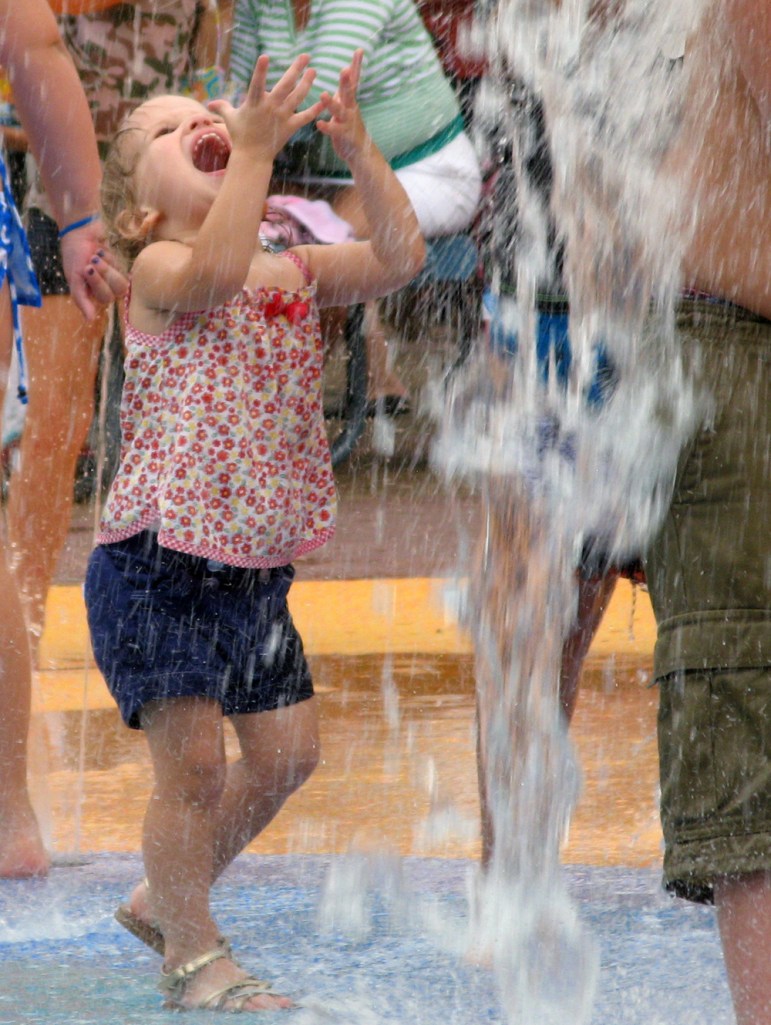 Toddler getting doused with water via Oaxacaborn
