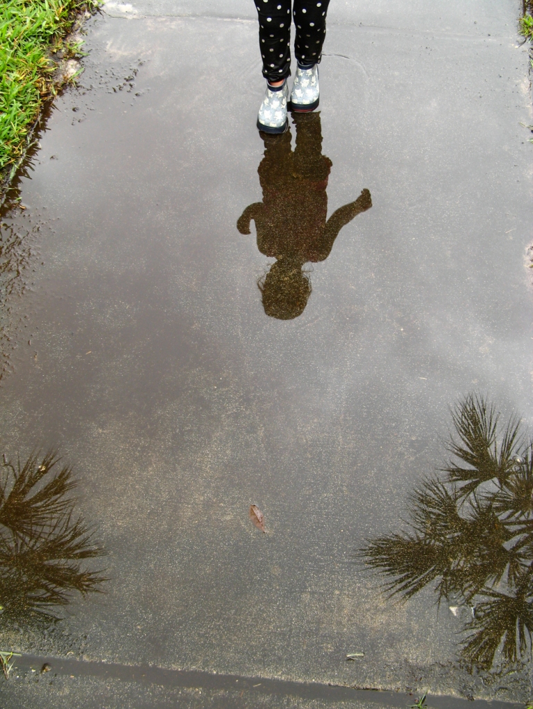 Portrait toddler and palm tree puddle reflection - via Oaxacaborn